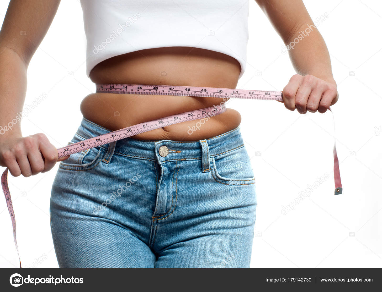Overweight woman with tape measure around waist. Stock Photo by